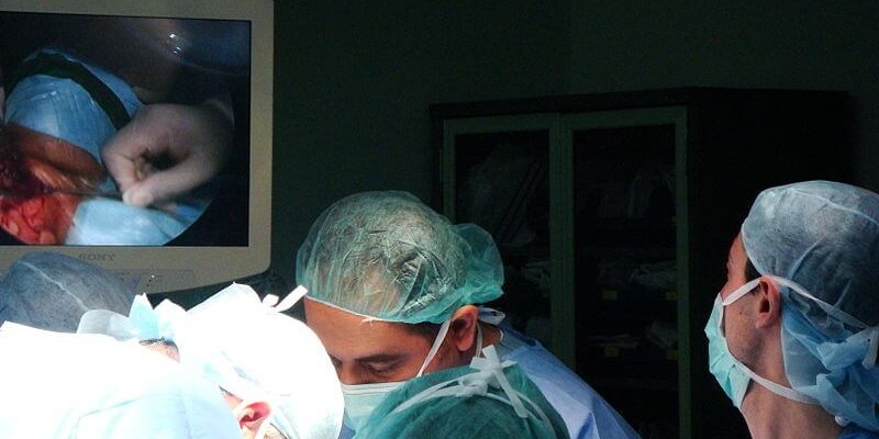 Doctors performing an abortion on a woman.