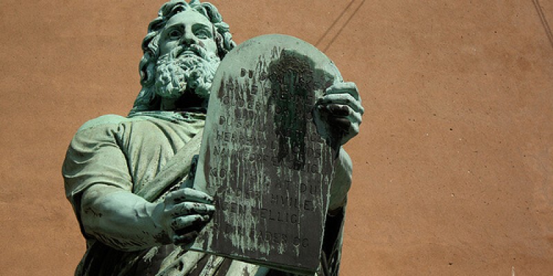 Statue of Moses bearing the 10 Commandments in a courtroom.