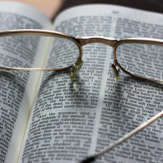 Open Bible with glasses on top