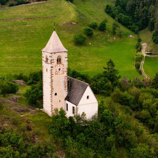 A church bell tower among trees