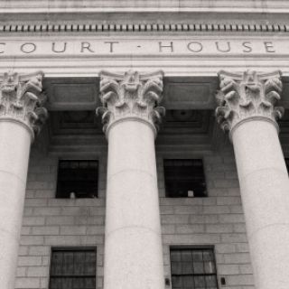 The front of a court house with columns.