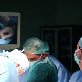 Doctors performing an abortion on a woman.