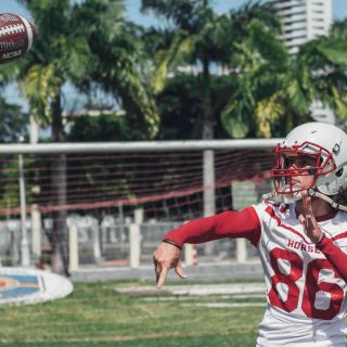 High School Football Player Throwing Ball