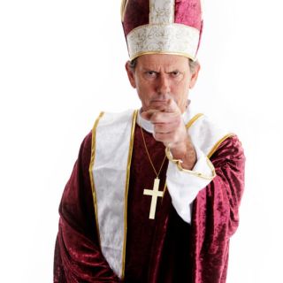 A man dressed as a religious official with a cross necklace pointing his finger in disapproval.